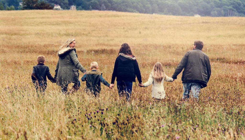 family walking field nature